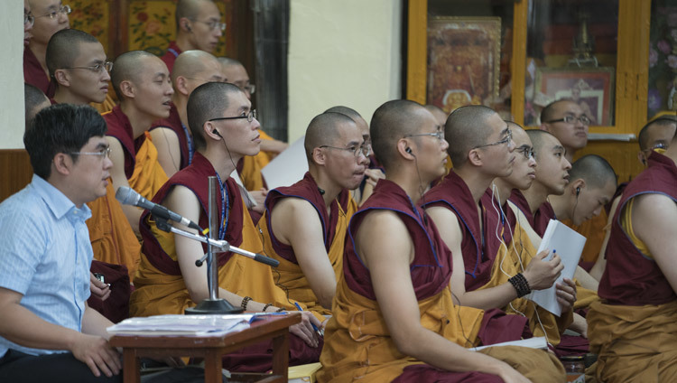 Members of the audience standing in the doorway of the Main Tibetan Temple to catch a glimpse of His Holiness the Dalai Lama during a break in his teachings in Dharamsala, HP, India on October 4, 2016. Photo/Tenzin Choejor/OHHDL Members of the audience standing in the doorway of the Main Tibetan Temple to catch a glimpse of His Holiness the Dalai Lama during a break in his teachings in Dharamsala, HP, India on October 4, 2016. Photo/Tenzin Choejor/OHHDL