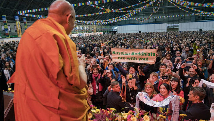 His Holiness the Dalai Lama greeting the audience of 4500 on his arrival on stage at the start of his teaching at Skonto Hall in Riga, Latvia on October 10, 2016. Photo/Tenzin Choejor/OHHDL His Holiness the Dalai Lama greeting the audience of 4500 on his arrival on stage at the start of his teaching at Skonto Hall in Riga, Latvia on October 10, 2016. Photo/Tenzin Choejor/OHHDL
