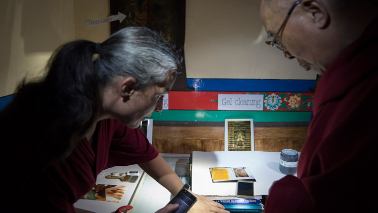 A member of a restoration team explaining to His Holiness the Dalai Lama some of the methods used to restore old Tibetan thangkas during his visit to Matho Monastery in Leh, Ladakh, J&K, India on July 20, 2017. Photo by Tenzin Choejor/OHHDL A member of a restoration team explaining to His Holiness the Dalai Lama some of the methods used to restore old Tibetan thangkas during his visit to Matho Monastery in Leh, Ladakh, J&K, India on July 20, 2017. Photo by Tenzin Choejor/OHHDL