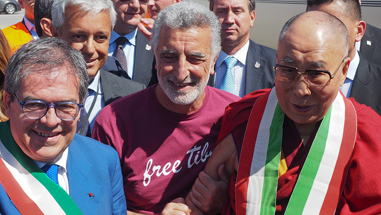 His Holiness the Dalai Lama being greeted at the airport by the Mayor of Catania, Enzo Bianco, and the Mayor of Messina, Renato Accorinti on his arrival in Catania, Sicily, Italy on September 15, 2017. Photo by Jeremy Russell His Holiness the Dalai Lama being greeted at the airport by the Mayor of Catania, Enzo Bianco, and the Mayor of Messina, Renato Accorinti on his arrival in Catania, Sicily, Italy on September 15, 2017. Photo by Jeremy Russell