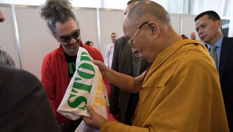 His Holiness the Dalai Lama looking at a t-shirt offered by Latvian singer Horens Stalbe after his meeting with Tibet supporters from the Baltic States in Riga, Latvia on September 24, 2017. Photo by Tenzin Choejor His Holiness the Dalai Lama looking at a t-shirt offered by Latvian singer Horens Stalbe after his meeting with Tibet supporters from the Baltic States in Riga, Latvia on September 24, 2017. Photo by Tenzin Choejor