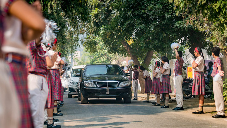 Students line the road to welcome His Holiness the Dalai Lama on his arrival at CJ DAV Public School in Meerut, UP, India on October 16, 2017. Photo by Tenzin Choejor Students line the road to welcome His Holiness the Dalai Lama on his arrival at CJ DAV Public School in Meerut, UP, India on October 16, 2017. Photo by Tenzin Choejor
