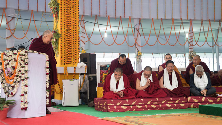 His Holiness the Dalai Lama thanking the Geshes who undertook the research work for the original compilation in Tibetan during the release ceremony for "Science and Philosophy in the Indian Buddhist Classics, Vol. 1: The Physical World" in Bodhgaya, Bihar, India on January 7, 2018. Photo by Lobsang Tsering His Holiness the Dalai Lama thanking the Geshes who undertook the research work for the original compilation in Tibetan during the release ceremony for "Science and Philosophy in the Indian Buddhist Classics, Vol. 1: The Physical World" in Bodhgaya, Bihar, India on January 7, 2018. Photo by Lobsang Tsering