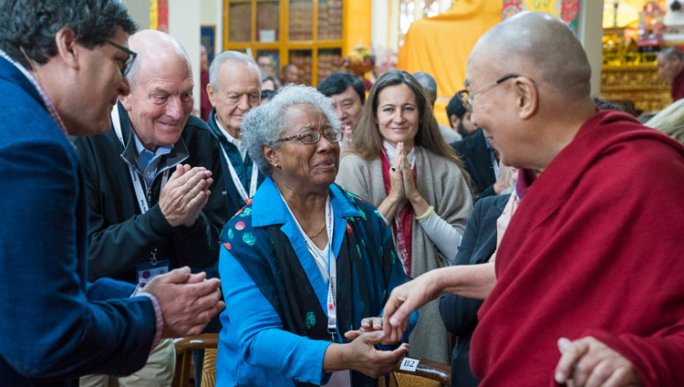 His Holiness the Dalai Lama greeting members of the audience as he arrives for the fourth day of the Mind & Life Conference at the Main Tibetan Temple in Dharamsala, HP, India on March 15, 2018. Photo by Tenzin Choejor His Holiness the Dalai Lama greeting members of the audience as he arrives for the fourth day of the Mind & Life Conference at the Main Tibetan Temple in Dharamsala, HP, India on March 15, 2018. Photo by Tenzin Choejor