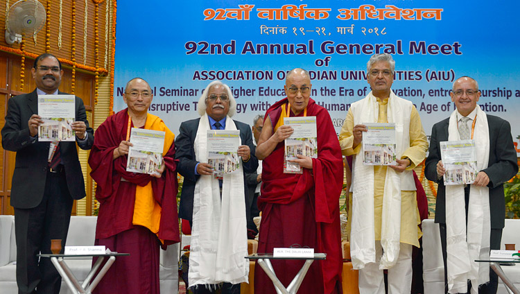 His Holiness the Dalai Lama and participants releasing the AIU Annual Report at the 92nd Annual Meet of Association of Indian Universities at CIHTS in Sarnath, UP, India on March 19, 2018. Photo by Lobsang Tsering His Holiness the Dalai Lama and participants releasing the AIU Annual Report at the 92nd Annual Meet of Association of Indian Universities at CIHTS in Sarnath, UP, India on March 19, 2018. Photo by Lobsang Tsering