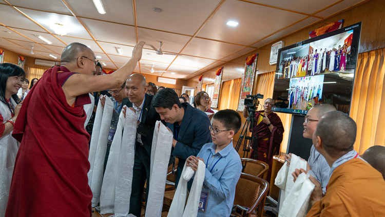 His Holiness the Dalai Lama waving to participants in Hanoi, Ho Chi Minh City and Hai Phong attending a meeting over a live teleconferencing link with a group from Vietnam at his residence in Dharamsala, HP, India on May 21, 2018. Photo by Tenzin Choejor His Holiness the Dalai Lama waving to participants in Hanoi, Ho Chi Minh City and Hai Phong attending a meeting over a live teleconferencing link with a group from Vietnam at his residence in Dharamsala, HP, India on May 21, 2018. Photo by Tenzin Choejor