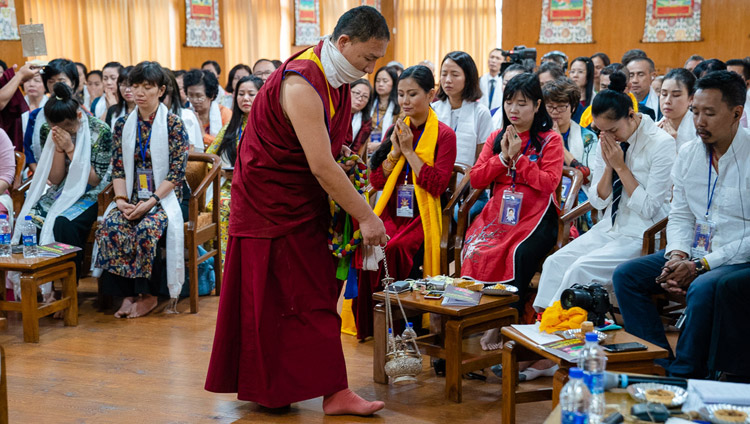 An assistant performing ritual cleansing with incense as His Holiness the Dalai lama gives the White Manjushri Permission on the second day of his meeting with groups from Vietnam at his residence in Dharamsala, HP, India on May 22, 2018. Photo by Tenzin Choejor An assistant performing ritual cleansing with incense as His Holiness the Dalai lama gives the White Manjushri Permission on the second day of his meeting with groups from Vietnam at his residence in Dharamsala, HP, India on May 22, 2018. Photo by Tenzin Choejor