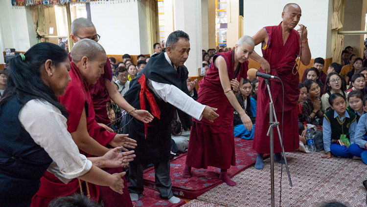 Members of the Dharamsala Buddhist Study Group demonstrating their debating skills at the start of His Holiness the Dalai Lama's teaching for young Tibetan students at the Main Tibetan Temple in Dharamsala, HP, India on June 6, 2018. Photo by Tenzin Phuntsok Members of the Dharamsala Buddhist Study Group demonstrating their debating skills at the start of His Holiness the Dalai Lama's teaching for young Tibetan students at the Main Tibetan Temple in Dharamsala, HP, India on June 6, 2018. Photo by Tenzin Phuntsok