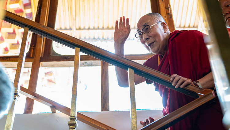 His Holiness the Dalai Lama waving to the gathered guests as he climbs the stairs to his residential quarters in Leh, Ladakh, J&K, India on July 3, 2018. Photo by Tenzin Choejor His Holiness the Dalai Lama waving to the gathered guests as he climbs the stairs to his residential quarters in Leh, Ladakh, J&K, India on July 3, 2018. Photo by Tenzin Choejor