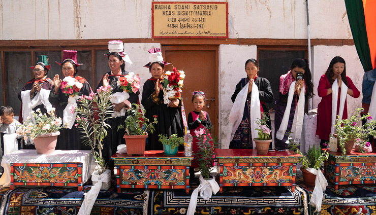 Local people standing alongside carved table bearing potted flowers to welcome Holiness the Dalai Lama to Nubra Valley in Ladakh, J&K, India on July 12, 2018. Photo by Tenzin Choejor Local people standing alongside carved table bearing potted flowers to welcome Holiness the Dalai Lama to Nubra Valley in Ladakh, J&K, India on July 12, 2018. Photo by Tenzin Choejor