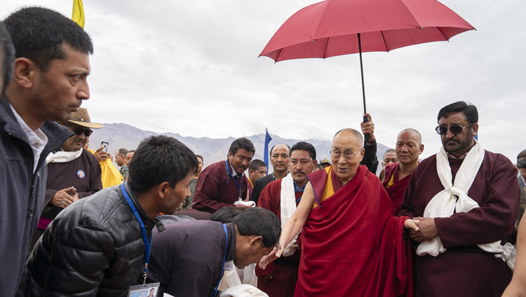 His Holiness the Dalai Lama being escorted to his motorcade on arrival at the helipad in Padum, Zanskar, J&K, India on July 21, 2018. Photo by Tenzin Choejor His Holiness the Dalai Lama being escorted to his motorcade on arrival at the helipad in Padum, Zanskar, J&K, India on July 21, 2018. Photo by Tenzin Choejor