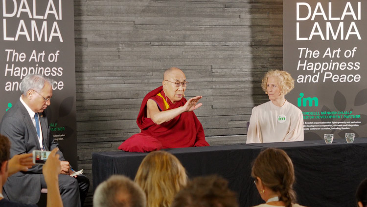 Secretary General of IM Ann Svensén looks on as His Holiness the Dalai Lama addresses members of the press in Malmö, Sweden on September 12, 2018. Photo by Jeremy Russell Secretary General of IM Ann Svensén looks on as His Holiness the Dalai Lama addresses members of the press in Malmö, Sweden on September 12, 2018. Photo by Jeremy Russell