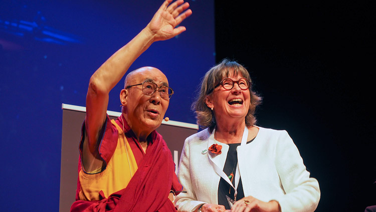 His Holiness the Dalai Lama waving to the grandchildren of the Chair of IM Birthe Müller as they stand together on stage at the conclusion of his talk in Malmö, Sweden on September 12, 2018. Photo by Jeremy Russell His Holiness the Dalai Lama waving to the grandchildren of the Chair of IM Birthe Müller as they stand together on stage at the conclusion of his talk in Malmö, Sweden on September 12, 2018. Photo by Jeremy Russell