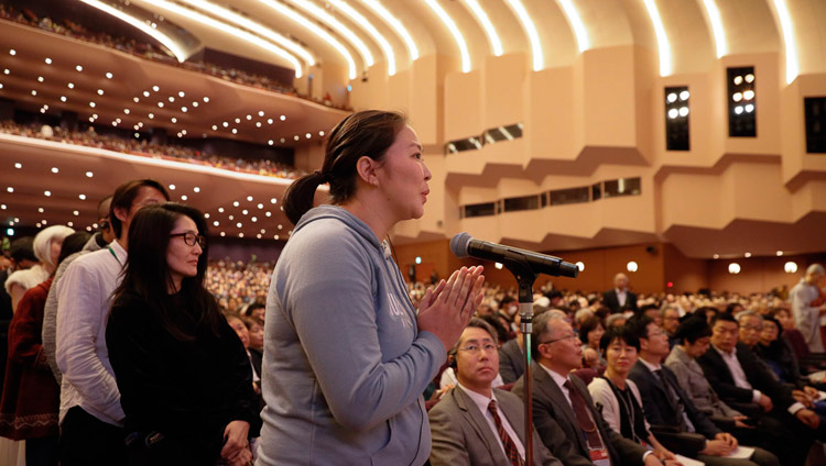 A member of the audience asking His Holiness the Dalai Lama a question during the Dialogue between Modern Science and Buddhist Science at the National Convention Hall in Yokohama, Japan on November 16, 2018. Photo by Tenzin Jigme A member of the audience asking His Holiness the Dalai Lama a question during the Dialogue between Modern Science and Buddhist Science at the National Convention Hall in Yokohama, Japan on November 16, 2018. Photo by Tenzin Jigme
