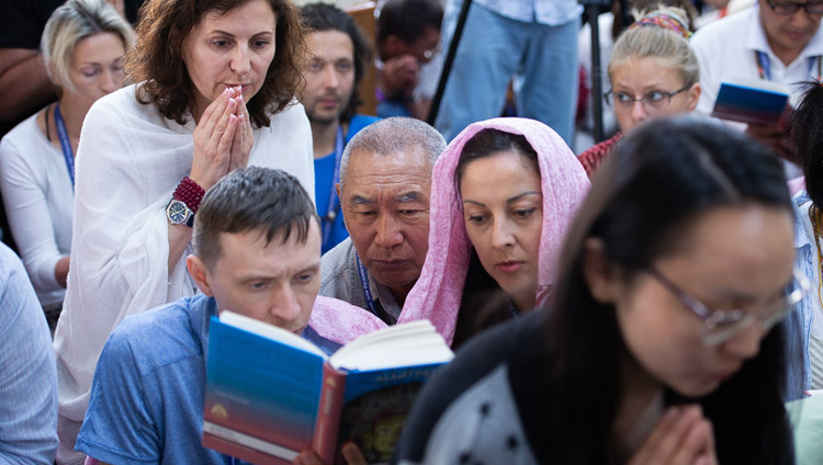 Members of the audience looking at the text on the final day of His Holiness the Dalai Lama's teaching at the request of Russian Buddhists at the Main Tibetan Temple in Dharamsala, HP, India on May 12, 2019. Photo by Lobsang Tsering Members of the audience looking at the text on the final day of His Holiness the Dalai Lama's teaching at the request of Russian Buddhists at the Main Tibetan Temple in Dharamsala, HP, India on May 12, 2019. Photo by Lobsang Tsering