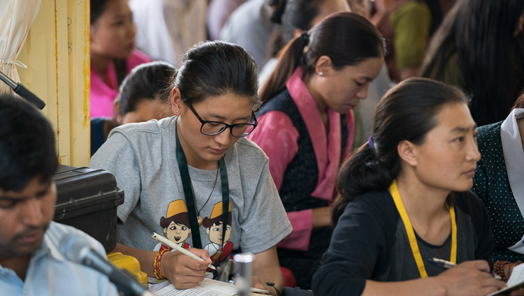 Members of the audience taking notes during His Holiness the Dalai Lama's teaching for young Tibetans at the Main Tibetan Temple in Dharamsala, HP, India on June 3, 2019. Photo by Tenzin Choejor Members of the audience taking notes during His Holiness the Dalai Lama's teaching for young Tibetans at the Main Tibetan Temple in Dharamsala, HP, India on June 3, 2019. Photo by Tenzin Choejor