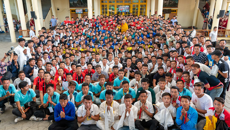 His Holiness the Dalai Lama poses with the 23 teams of young Tibetans from Europe, America and many parts of India, who are participating in the 25th Gyalyum Chenmo Memorial Gold Cup football tournament in the Main Tibetan Temple courtyard in Dharamsala, HP, India on June 5, 2019. Photo by Tenzin Choejor His Holiness the Dalai Lama poses with the 23 teams of young Tibetans from Europe, America and many parts of India, who are participating in the 25th Gyalyum Chenmo Memorial Gold Cup football tournament in the Main Tibetan Temple courtyard in Dharamsala, HP, India on June 5, 2019. Photo by Tenzin Choejor