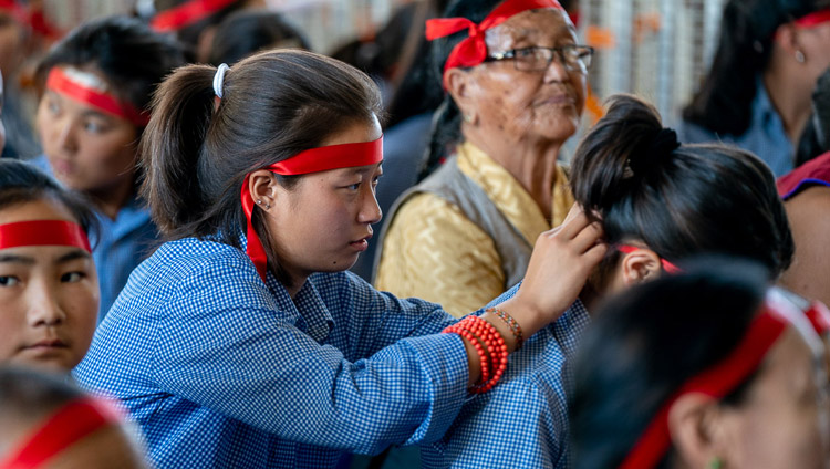 Tibetan students in the audience preparing ritual blindfolds used in the Avalokiteshvara Empowerment given by His Holiness the Dalai Lama at the Main Tibetan Temple in Dharamsala, HP, India on June 5, 2019. Photo by Tenzin Choejor Tibetan students in the audience preparing ritual blindfolds used in the Avalokiteshvara Empowerment given by His Holiness the Dalai Lama at the Main Tibetan Temple in Dharamsala, HP, India on June 5, 2019. Photo by Tenzin Choejor