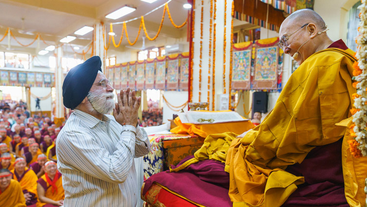 His Holiness the Dalai Lama greeting a Sikh man invited to come to the stage during the Avalokiteshvara Empowerment at the Main Tibetan Temple in Dharamsala, HP, India on June 5, 2019. Photo by Tenzin Choejor His Holiness the Dalai Lama greeting a Sikh man invited to come to the stage during the Avalokiteshvara Empowerment at the Main Tibetan Temple in Dharamsala, HP, India on June 5, 2019. Photo by Tenzin Choejor
