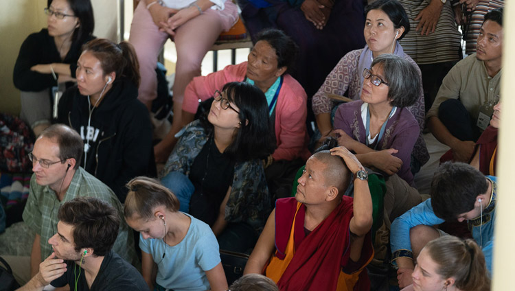 Members of the audience sitting on the veranda outside the Main Tibetan Temple watching His Holiness the Dalai Lama on a TV screen during the first day of his teachings in Dharamsala, HP, India on September 4, 2019. Photo by Tenzin Choejor Members of the audience sitting on the veranda outside the Main Tibetan Temple watching His Holiness the Dalai Lama on a TV screen during the first day of his teachings in Dharamsala, HP, India on September 4, 2019. Photo by Tenzin Choejor