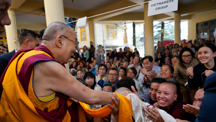 His Holiness the Dalai Lama greeting members of the audience os he departs the Main Tibetan Temple at the conclusion of the first day of his teaching in Dharamsala, HP, India on October 3, 2019. Photo by Ven Tenzin Jamphel His Holiness the Dalai Lama greeting members of the audience os he departs the Main Tibetan Temple at the conclusion of the first day of his teaching in Dharamsala, HP, India on October 3, 2019. Photo by Ven Tenzin Jamphel