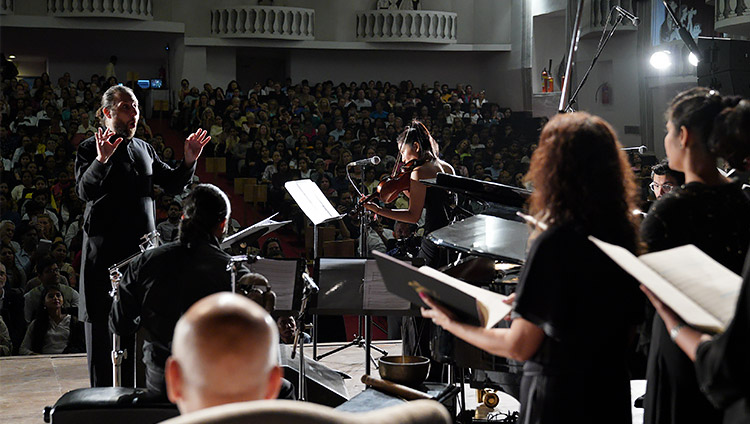 The Goa University choir, accompanied by violin, piano and percussion performing a specially written composition in honor of His Holiness the Dalai Lama before his talk at Kala Academy in Goa, India on December 11, 2019. Photo by Lobsang Tsering The Goa University choir, accompanied by violin, piano and percussion performing a specially written composition in honor of His Holiness the Dalai Lama before his talk at Kala Academy in Goa, India on December 11, 2019. Photo by Lobsang Tsering