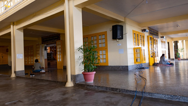 The Korean and Portuguese interpreters sitting at the Main Tibetan Temple translating on the second day of His Holiness's teachings from his residence in Dharamsala, HP, India on May 17, 2020. Photo by Lobsang Tsering