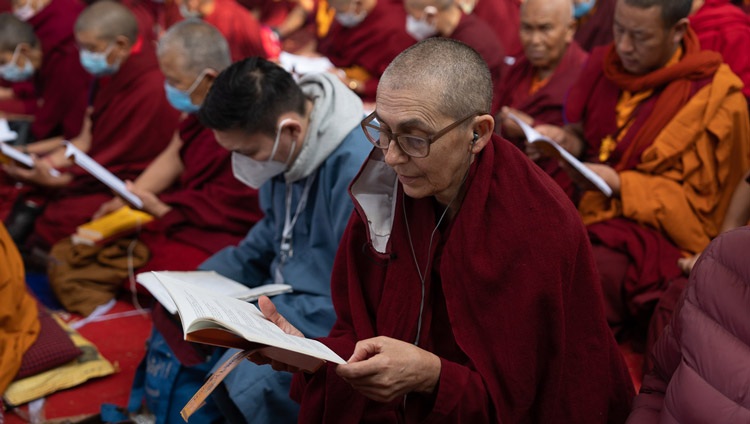 Members of the crowd following along with the text "Commentary on Bodhichitta" by Nagarjuna on the third day of His Holiness the Dalai Lama's teachings at the Kalachakra Teaching Ground in Bodhgaya, Bihar, India on December 31, 2022. Photo by Tenzin Choejor Members of the crowd following along with the text "Commentary on Bodhichitta" by Nagarjuna on the third day of His Holiness the Dalai Lama's teachings at the Kalachakra Teaching Ground in Bodhgaya, Bihar, India on December 31, 2022. Photo by Tenzin Choejor