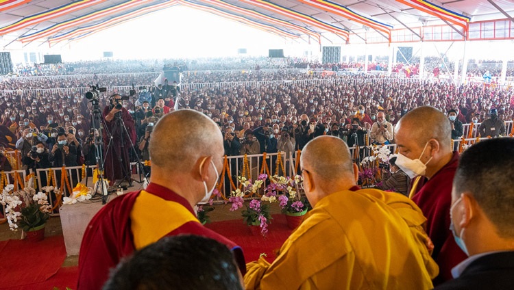 His Holiness the Dalai Lama waving to the crowd at the end of the Long Life Prayers at the Kalachakra Teaching Ground in Bodhgaya, Bihar, India on January 1, 2023. Photo by Tenzin Choejor