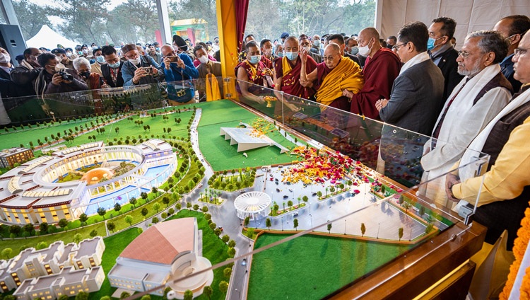 His Holiness the Dalai Lama blessing a model of the proposed building before taking his seat on stage at the the Foundation Stone Laying Ceremony of the Dalai Lama Centre for Tibetan & Indian Ancient Wisdom in Bodhgaya, Bihar, India on January 3, 2023. Photo by Tenzin Choejor His Holiness the Dalai Lama blessing a model of the proposed building before taking his seat on stage at the the Foundation Stone Laying Ceremony of the Dalai Lama Centre for Tibetan & Indian Ancient Wisdom in Bodhgaya, Bihar, India on January 3, 2023. Photo by Tenzin Choejor
