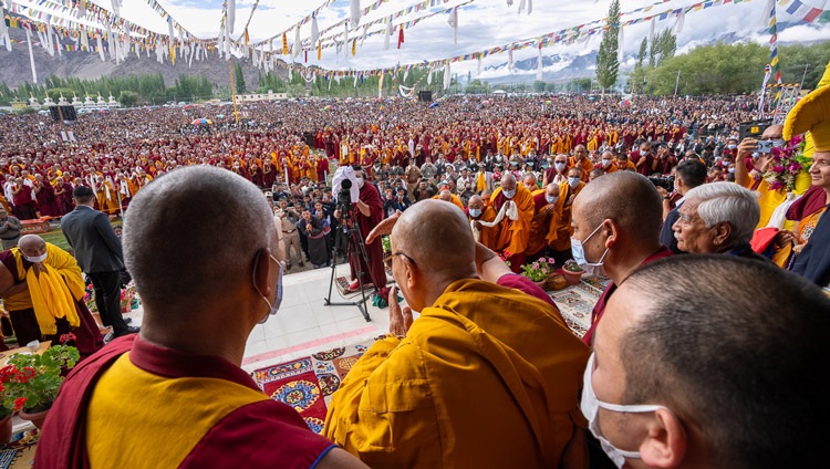 His Holiness the Dalai Lama waving to the crowd estimated at 45,000 on the first day of teachings at the Shewatsel Teaching Area in Leh, Ladakh UT, India on July 21, 2023. Photo by Tenzin Choejor His Holiness the Dalai Lama waving to the crowd estimated at 45,000 on the first day of teachings at the Shewatsel Teaching Area in Leh, Ladakh UT, India on July 21, 2023. Photo by Tenzin Choejor