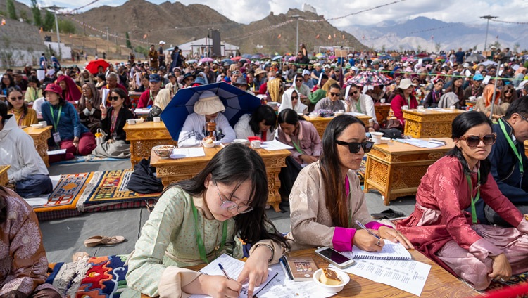 Students taking notes during His Holiness the Dalai Lama's teaching at Lamdon Model Senior Secondary School's Golden Jubilee Celebration in Leh, Ladakh, India on August 7, 2023. Photo by Tenzin Choejor Students taking notes during His Holiness the Dalai Lama's teaching at Lamdon Model Senior Secondary School's Golden Jubilee Celebration in Leh, Ladakh, India on August 7, 2023. Photo by Tenzin Choejor