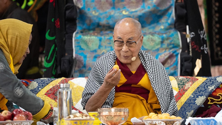 is Holiness the Dalai Lama about to take a bite of apricot during his talk to members of the Muslim community at Imam Bargah, Chuchot Yokma, in Leh, Ladakh, India on August 12, 2023. Photo by Tenzin Choejor is Holiness the Dalai Lama about to take a bite of apricot during his talk to members of the Muslim community at Imam Bargah, Chuchot Yokma, in Leh, Ladakh, India on August 12, 2023. Photo by Tenzin Choejor