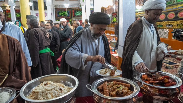Members of the audience serving themselves lunch during the program with His Holiness the Dalai Lama at Imam Bargah, Chuchot Yokma, in Leh, Ladakh, India on August 12, 2023. Photo by Tenzin Choejor Members of the audience serving themselves lunch during the program with His Holiness the Dalai Lama at Imam Bargah, Chuchot Yokma, in Leh, Ladakh, India on August 12, 2023. Photo by Tenzin Choejor
