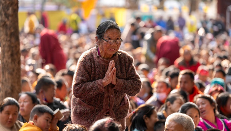 A member of the crowd paying her respects during His Holiness the Dalai Lama's teaching at Sed-Gyued Monastery in Salugara, West Bengal, India on December 14, 2023. Photo by Tenzin Choejor A member of the crowd paying her respects during His Holiness the Dalai Lama's teaching at Sed-Gyued Monastery in Salugara, West Bengal, India on December 14, 2023. Photo by Tenzin Choejor