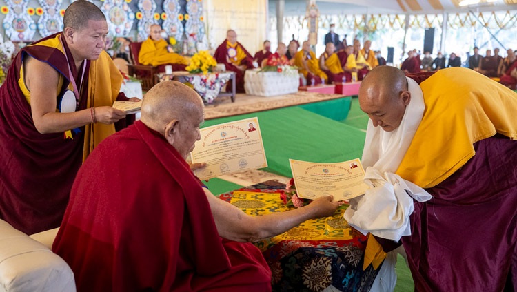 Ganden Tri Rinpoché presenting degrees to the Geshe graduates during the Gelukpa University Convocation and the Award of Geshé Lharampa Degrees at the Kalachakra Ground in Bodhgaya, Bihar, India on January 3, 2024. Photo by Ven Zamling Norbu Ganden Tri Rinpoché presenting degrees to the Geshe graduates during the Gelukpa University Convocation and the Award of Geshé Lharampa Degrees at the Kalachakra Ground in Bodhgaya, Bihar, India on January 3, 2024. Photo by Ven Zamling Norbu