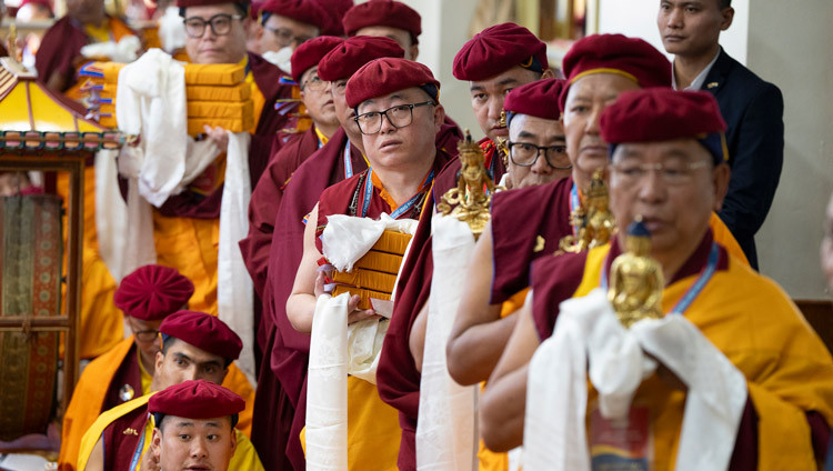 Members Drukpa Kagyu tradition lined up holding offerings for His Holiness the Dalai Lama during the Long Life Prayers at the Main Tibetan Temple in Dharamsala, HP, India on April 2, 2025. Photo by Tenzin Choejor
