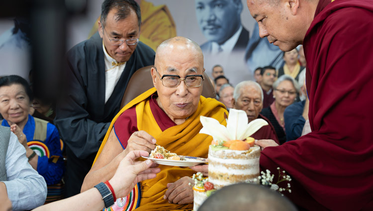 His Holiness the Dalai Lama having the first piece of his birthday cake during during celebrations in honor of his 90th birthday at the Main Tibetan Temple courtyard in Dharamsala, HP, India on July 6, 2025. Photo by Tenzin Choejor