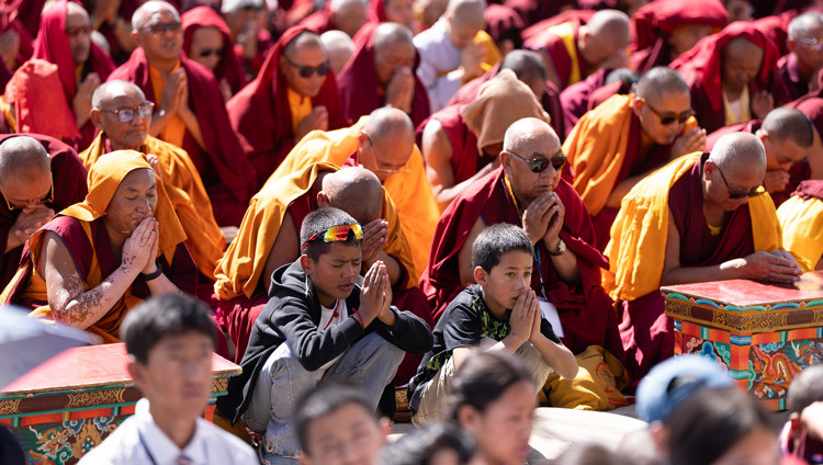 Members of the crowd repeating after His Holiness the Dalai Lama lines generating the awakening mind during his teaching at the Kalachakra Teaching Ground in Leh, Ladakh, India on August 16, 2025. Photo by Tenzin Choejor