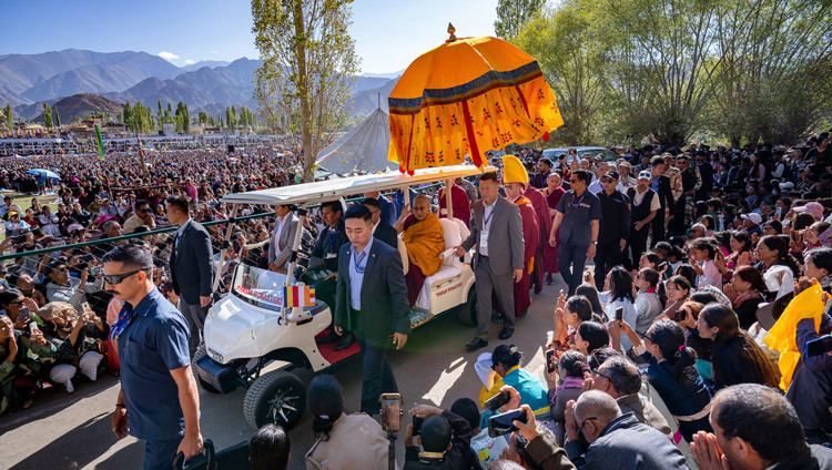 His Holiness the Dalai Lama riding in a golf cart from his residence to the pavilion at the Kalachakra Teaching Ground in Leh, Ladakh, India on August 17, 2025. Photo by Tenzin Choejor