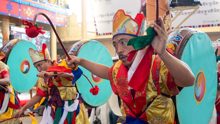 Monks from Gongkar Chödé beat the large drums strapped to their backs in welcoming His Holiness the Dalai Lama as he arrives to attend Long Life Prayers at the Main Tibetan Temple in Dharamsala, HP, India on September 10, 2025. Photo by Tenzin Choejor