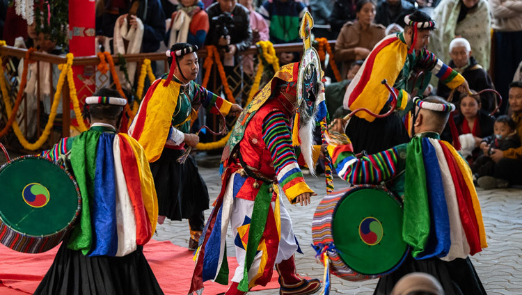Costumed dancers beating drums leading the way as His Holiness the Dalai Lama makes his way to the Main Tibetan Temple to attend a Long Life Offering Ceremony in Dharamsala, HP, India on October 8, 2025. Photo by Tenzin Choejor