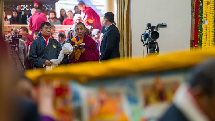 A monk from Namgyal Monastery reading out a declaration paying homage to His Holiness the Dalai Lama during the Long Life Prayers at the Main Tibetan Temple in Dharamsala, HP, India on February 23, 2026. Photo by Tenzin Choejor