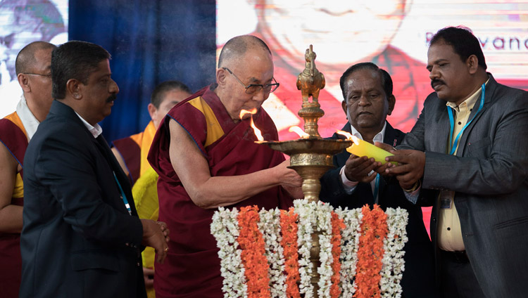 His Holiness the Dalai Lama joins in lighting a lamp at the start of the program at Tumkur University in Tumakuru, Karnataka, India on December 26, 2017. Photo by Tenzin Choejor His Holiness the Dalai Lama joins in lighting a lamp at the start of the program at Tumkur University in Tumakuru, Karnataka, India on December 26, 2017. Photo by Tenzin Choejor
