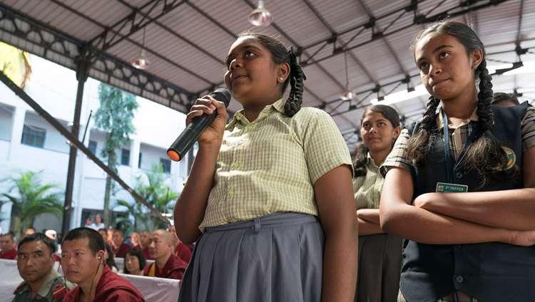 A young student asking His Holiness the Dalai Lama a question during his talk at Tumkur University in Tumakuru, Karnataka, India on December 26, 2017. Photo by Tenzin Choejor A young student asking His Holiness the Dalai Lama a question during his talk at Tumkur University in Tumakuru, Karnataka, India on December 26, 2017. Photo by Tenzin Choejor