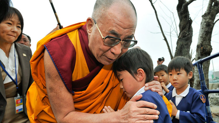 His Holiness the Dalai Lama comforting a young survivor during his visit to the Tsunami devastated region of Sendai, Japan on November 5, 2011. (Photo by Tenzin Choejor/OHHDL) His Holiness the Dalai Lama comforting a young survivor during his visit to the Tsunami devastated region of Sendai, Japan on November 5, 2011. (Photo by Tenzin Choejor/OHHDL)