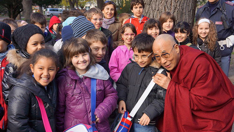 His Holiness the Dalai Lama stops to talk to a group of school children on his way to the Provincial Offices in Bolzano, South Tyrol, Italy, on April 10, 2013.(Photo by Jeremy Russell/OHHDL) His Holiness the Dalai Lama stops to talk to a group of school children on his way to the Provincial Offices in Bolzano, South Tyrol, Italy, on April 10, 2013.(Photo by Jeremy Russell/OHHDL)